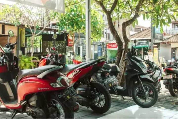 Row of red and black scooters parked outdoors in Ubud Bali &ndash; GoTravela Indonesia